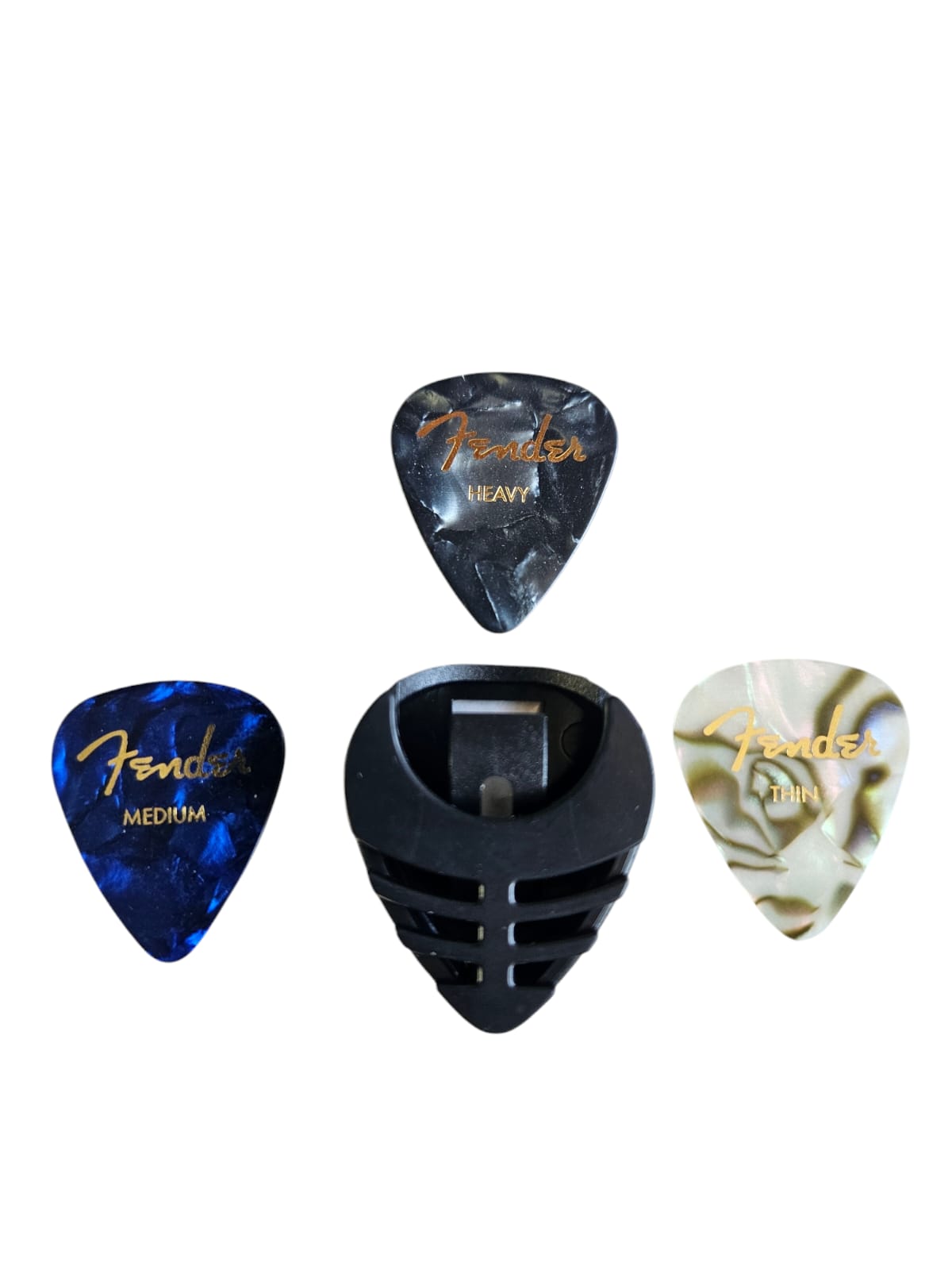 Portapúas con 3 púas Fender de diferentes calibres (delgado, medio y dura) para guitarra.