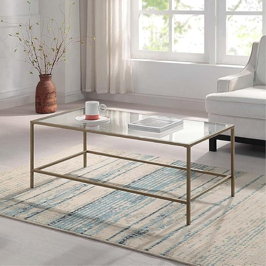 Mesa de centro rectangular, con vidrio temperado y marco de metal dorado. 111cms x 52.7cms x 45.4cms